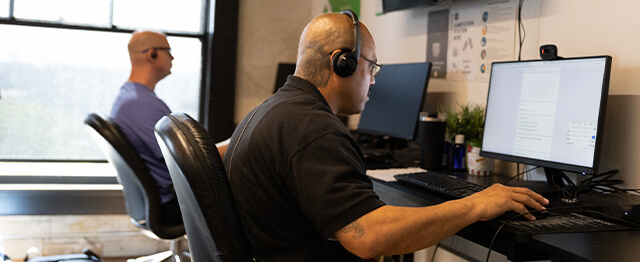 two men sitting at computers